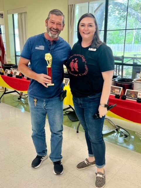 John Nelson, right, from Cleveland, Texas, won first place for his Papa J’s chili. He accepted his award from Amanda Di Dio, City of Katy Social Services Director.
